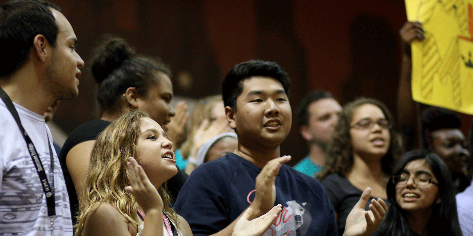 Students cheering at a convocation. 